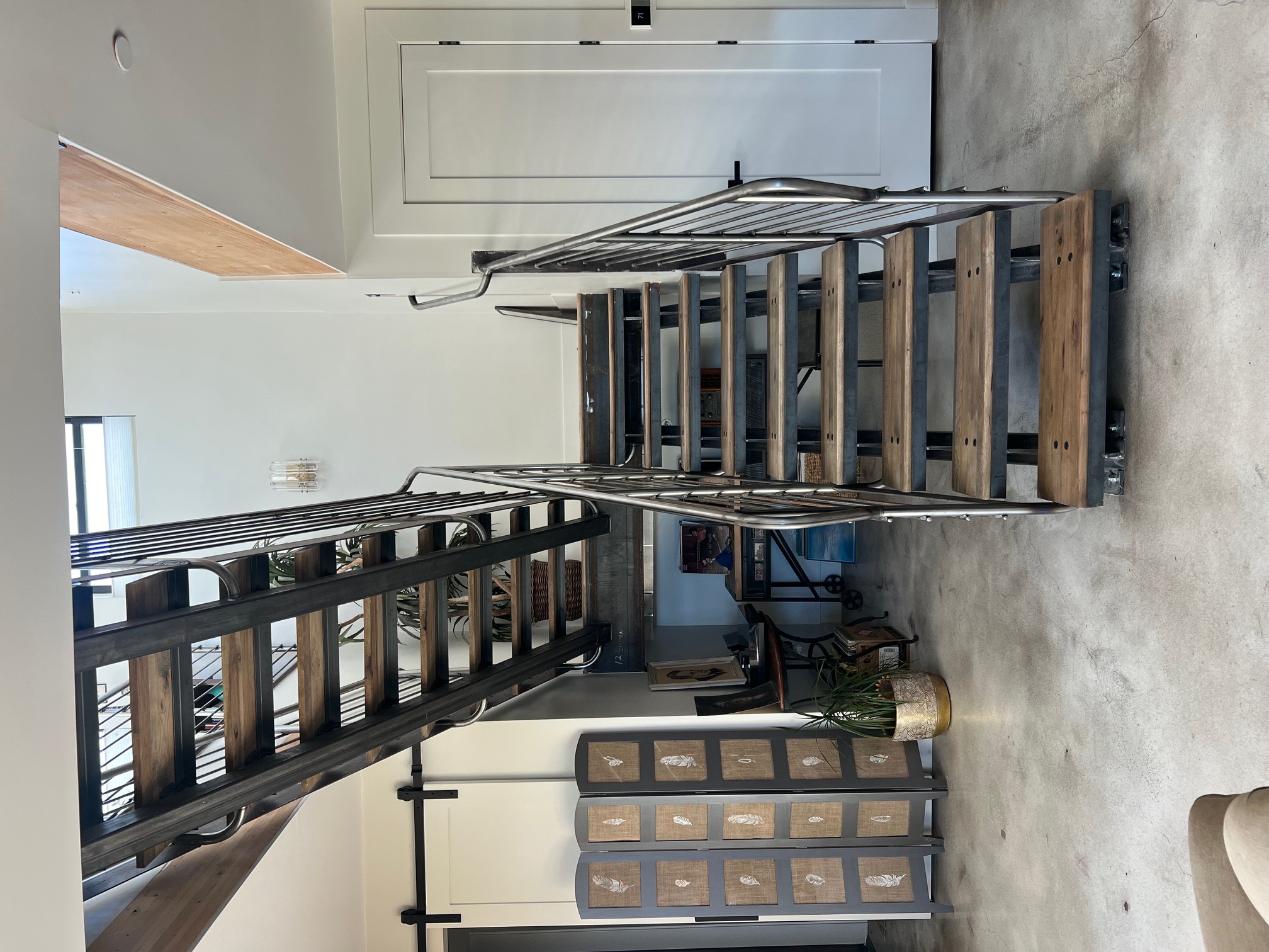Open riser staircase with wood treads and stainless rod railings