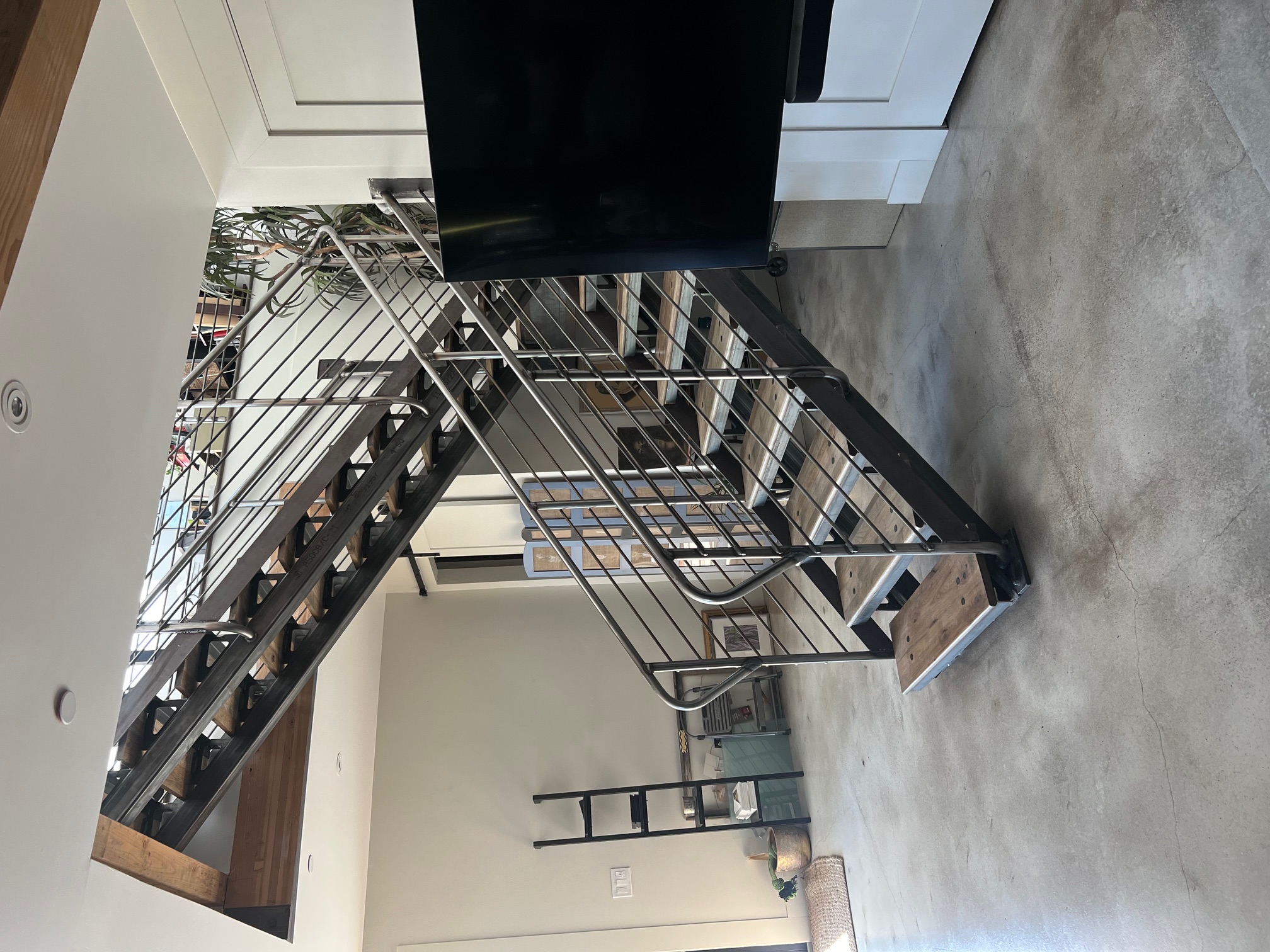 Industrial double stringer staircase with horizontal rod railings